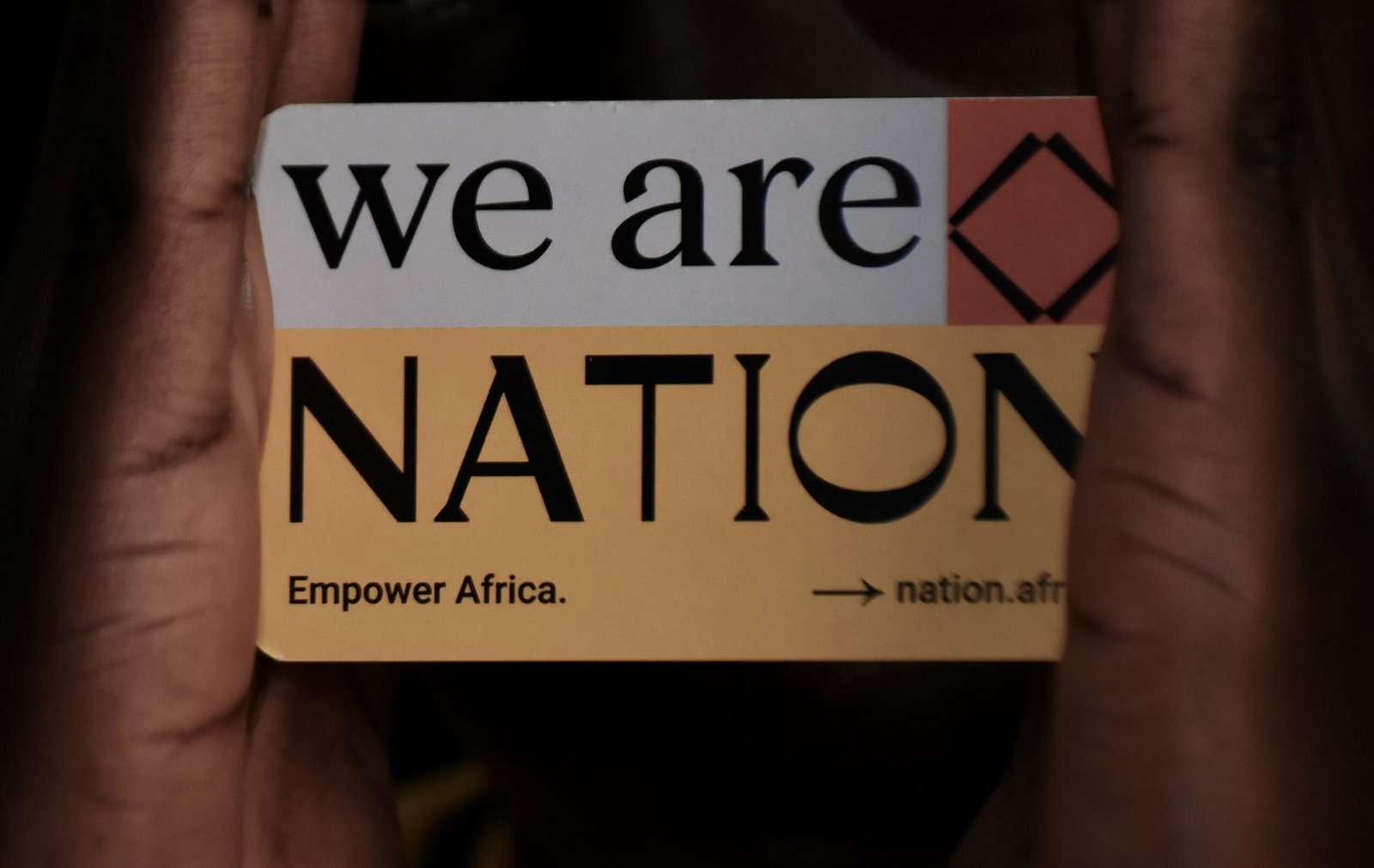 a person holding a sign that says we are nation